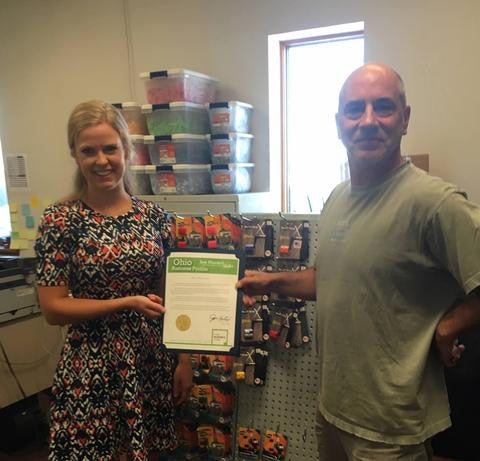 Josette Burns of the Ohio Secretary of State's Office, presenting Reel Grip with its Ohio Business Profile Proclamation